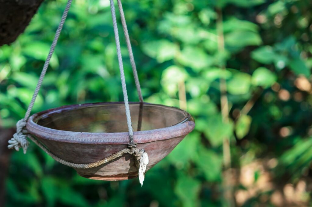 Birdbath bowl suspended with rope