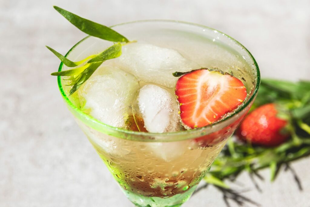 Summer cocktail lemonade with ice cream, strawberries and tarragon