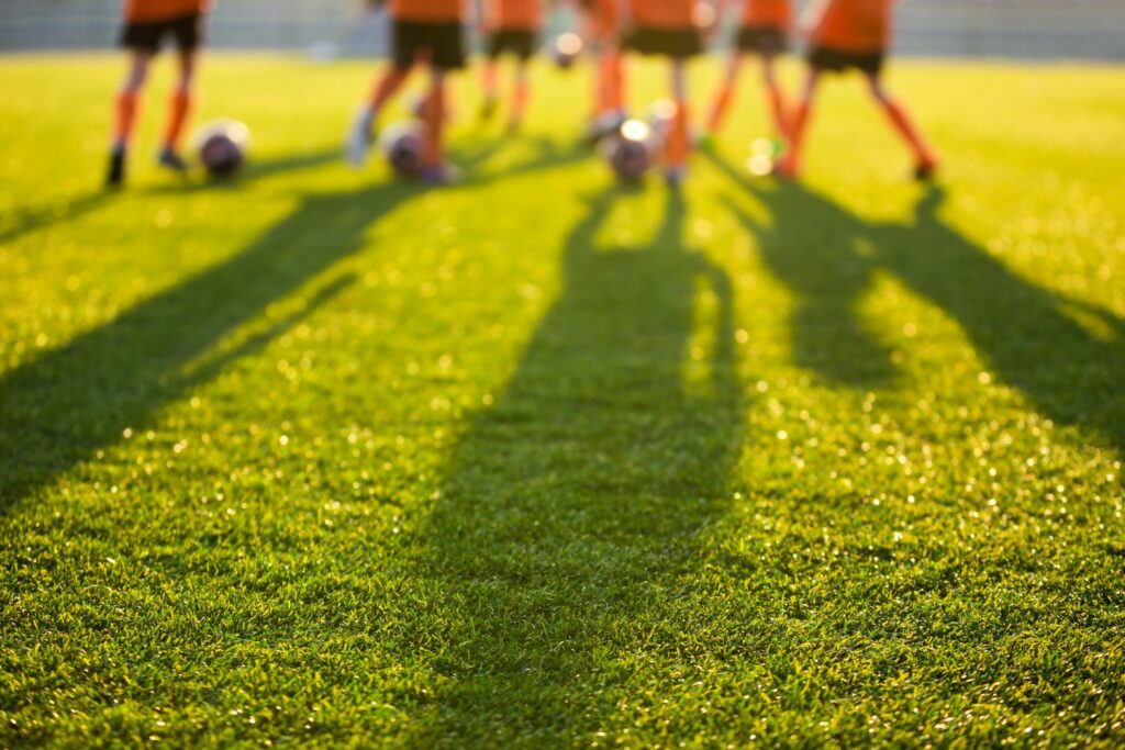 Children playing football on the lawn