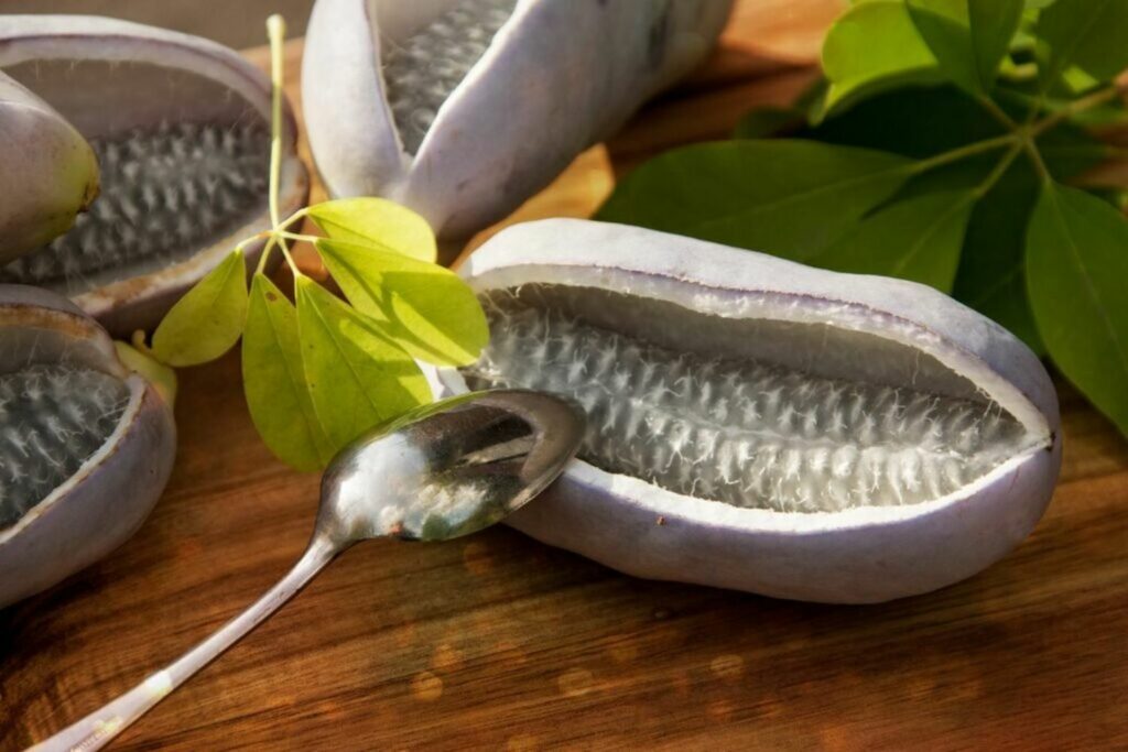 Sliced chocolate vine fruit with purple skin filled with white seeds