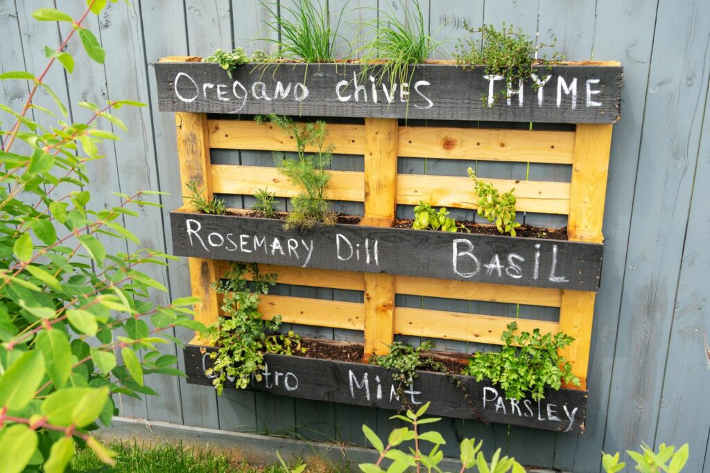 Pallet herb garden on wall with chalk writing