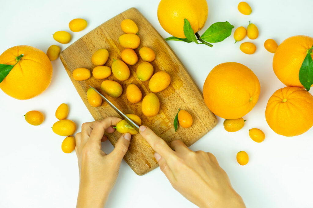 Cutting kumquats on chopping board