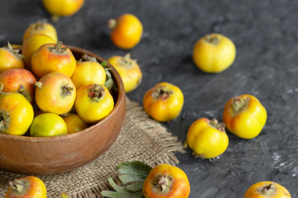 Yellow azarole fruits in bowl