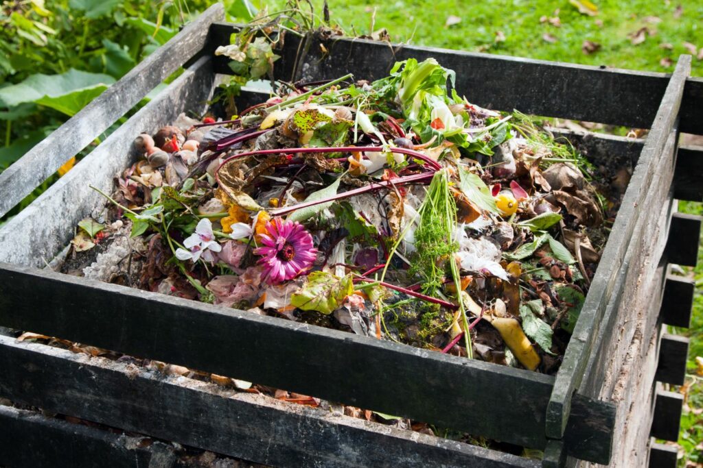 Filled wooden compost bin