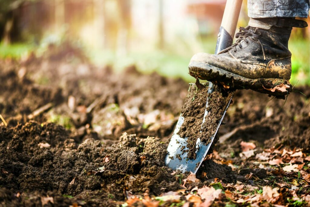 Digging up soil with spade