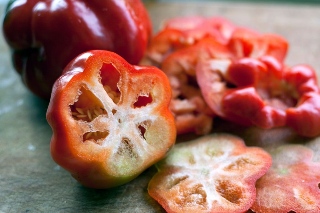 sliced tomato pepper reveals seeds