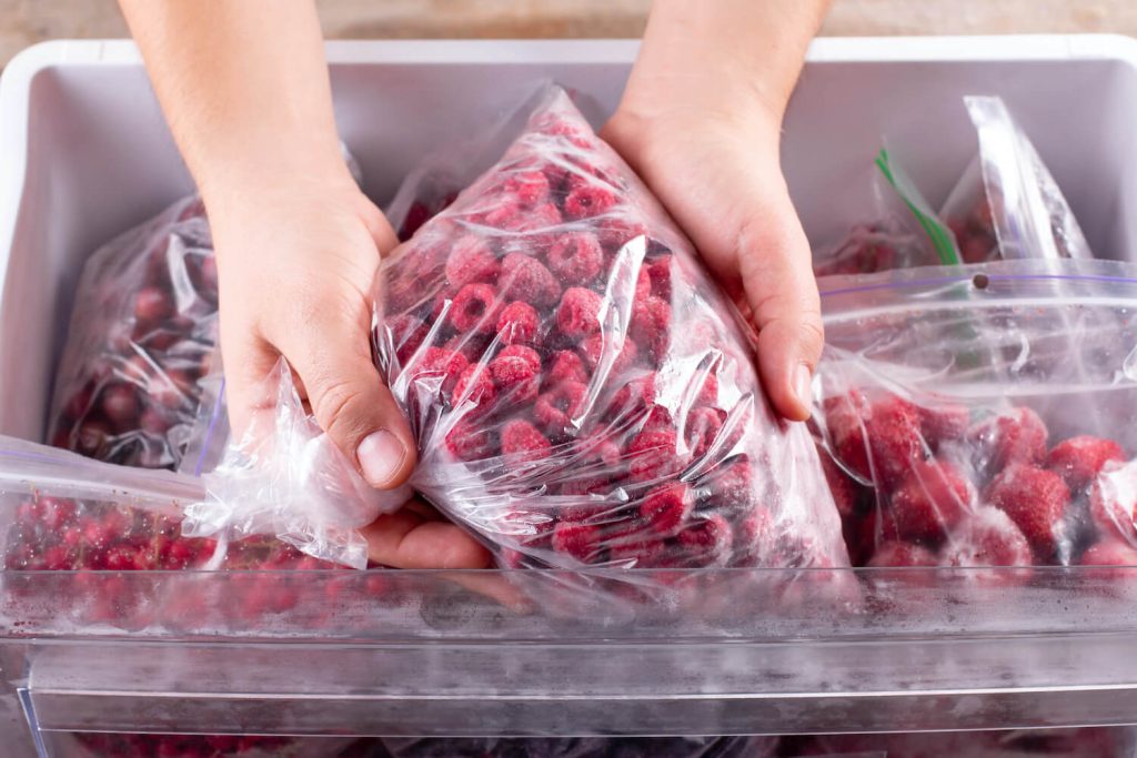 Freezer bag full of raspberries