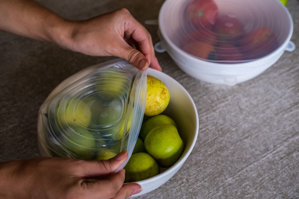 Person fitting lid to fruit bowl